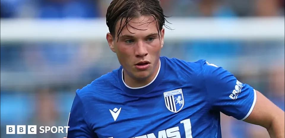 Player in blue kit running on the pitch
