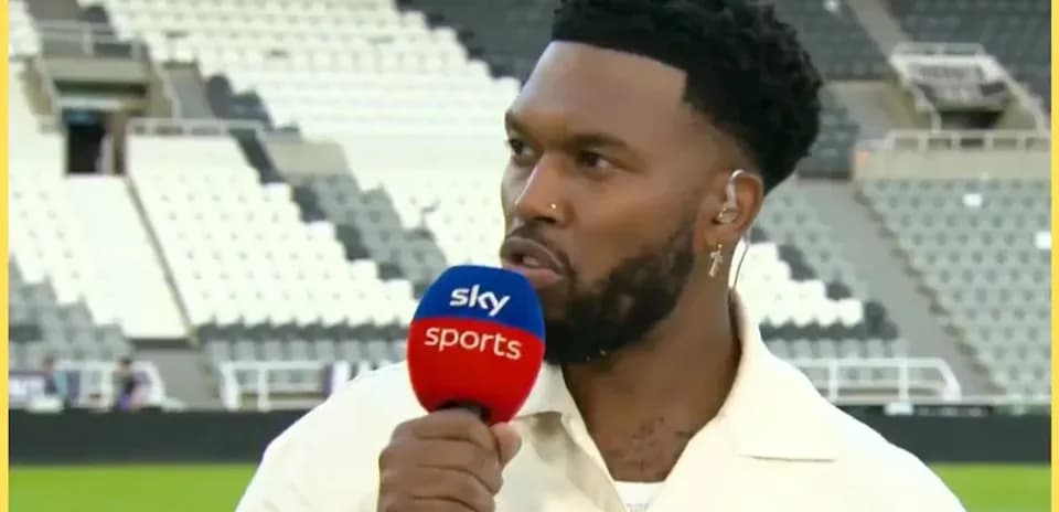 Sports commentator speaking into microphone on field