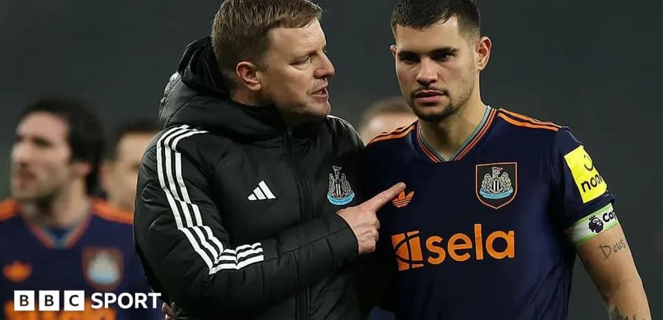Coach speaking to player on the field after match