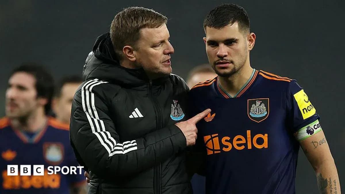 Coach speaking to player on the field after match
