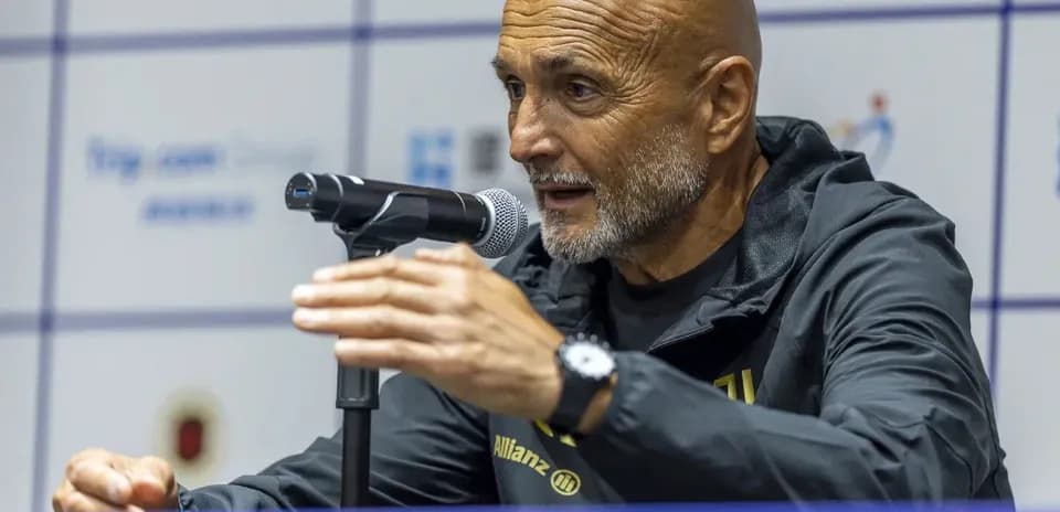 Manager speaking at press conference with microphone
