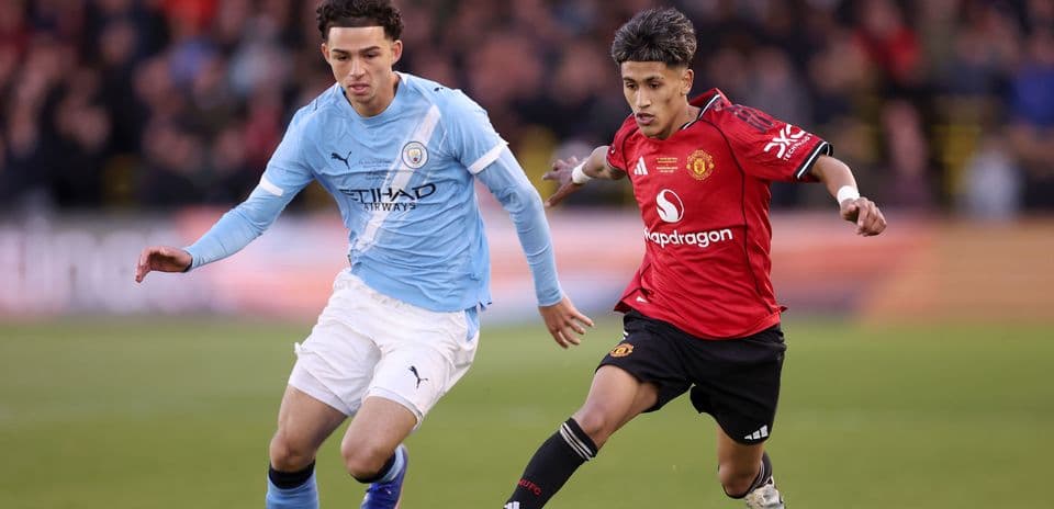 Two players competing for the ball during match