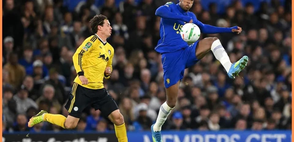 Player kicking the ball during football match