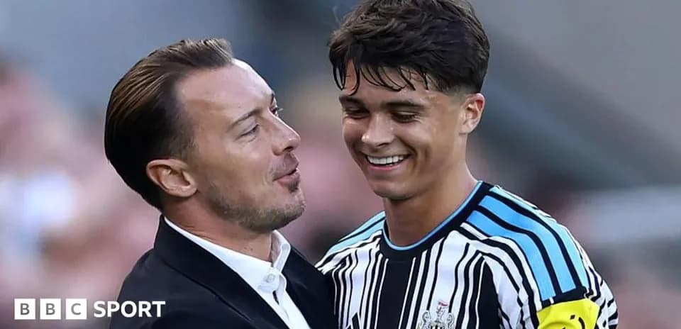 Coach and player sharing a moment on the pitch