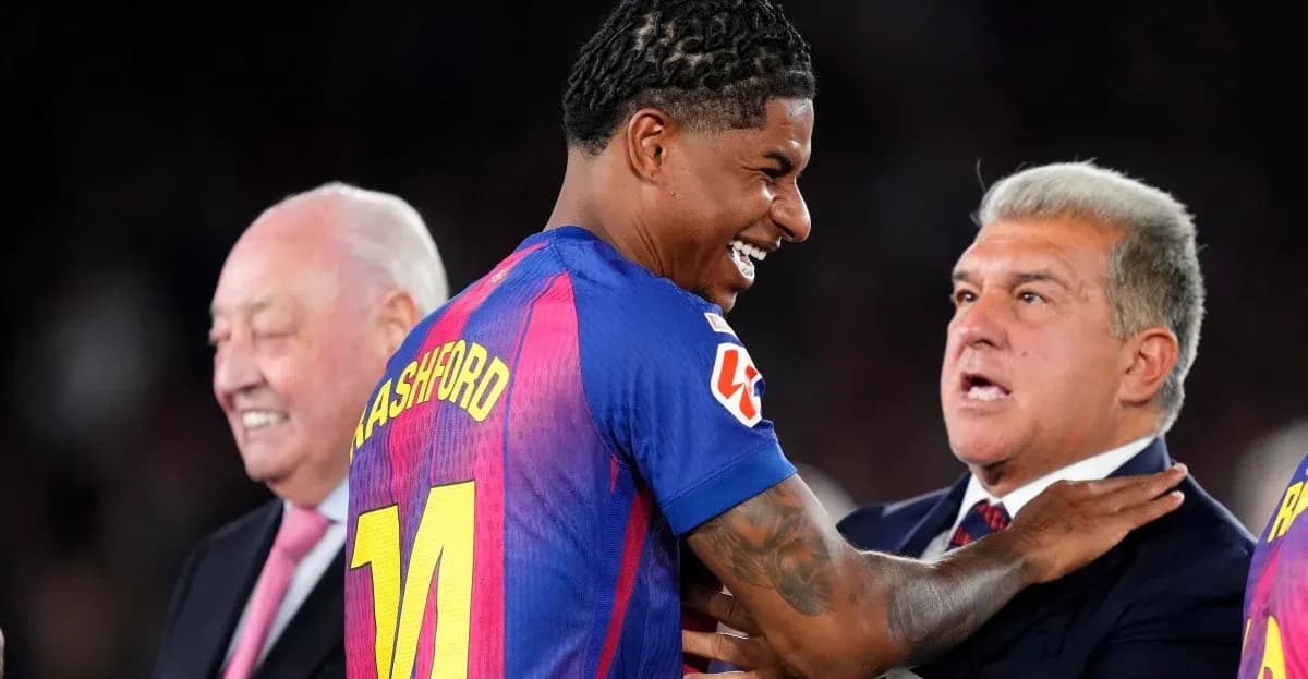 Player in Barcelona jersey smiling with officials