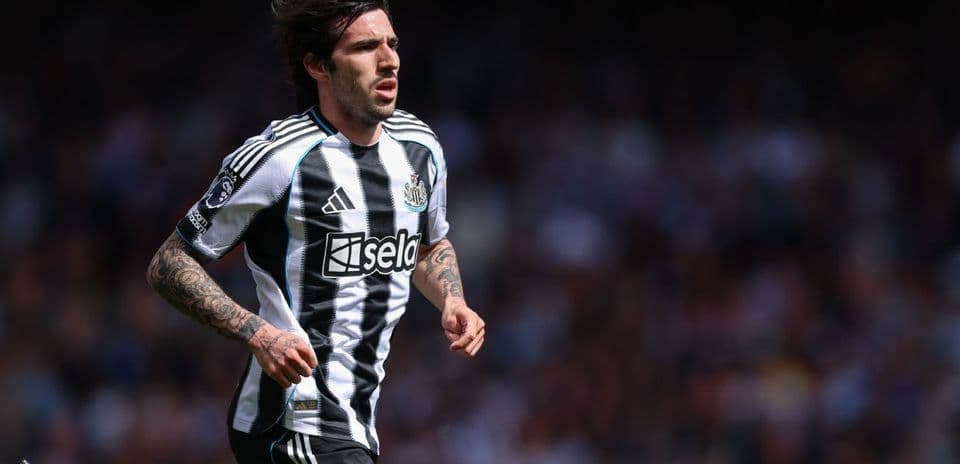 Player running on the pitch in Newcastle kit