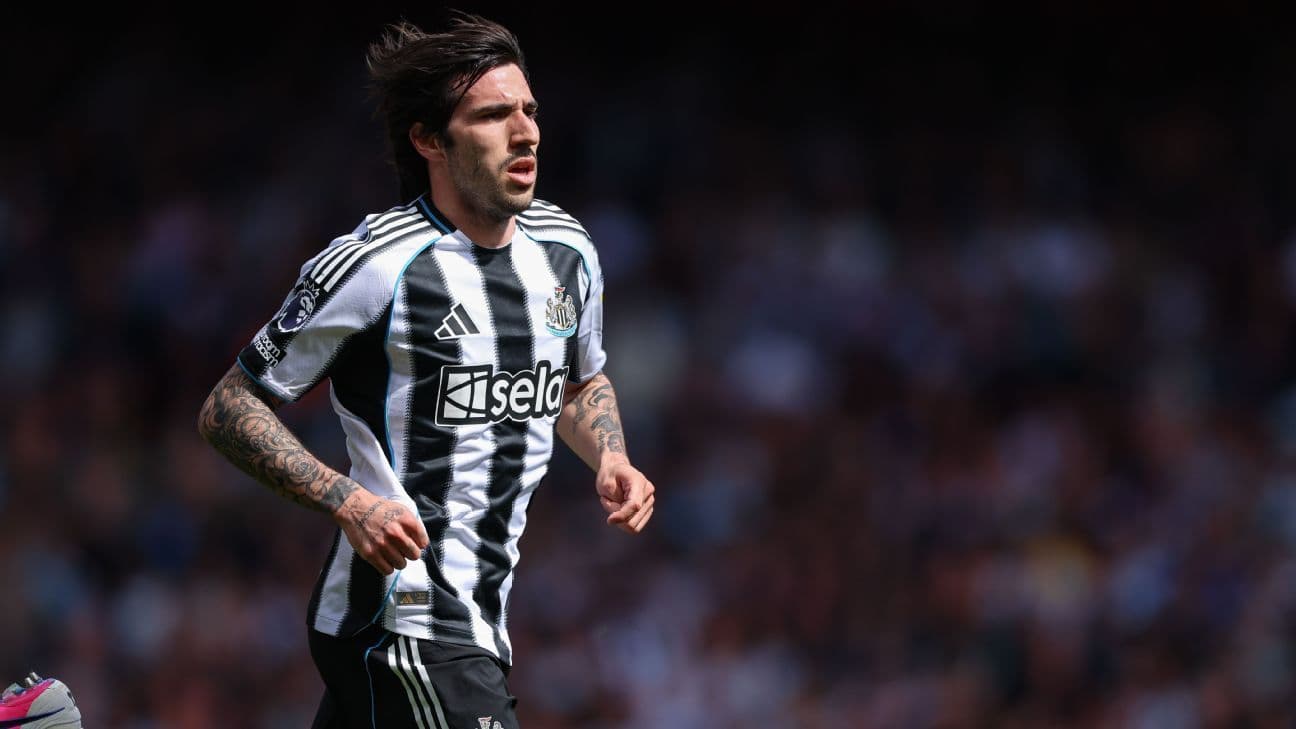 Player running on the pitch in Newcastle kit