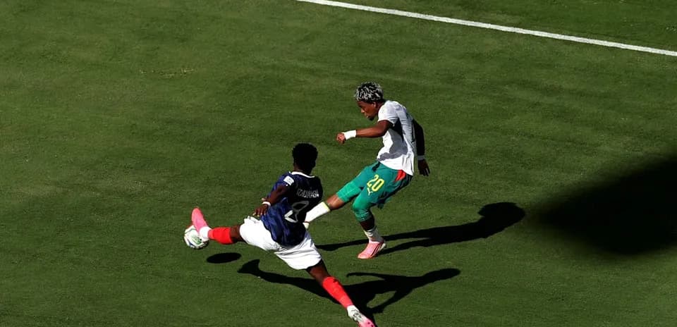 Player tackling opponent during soccer match on field