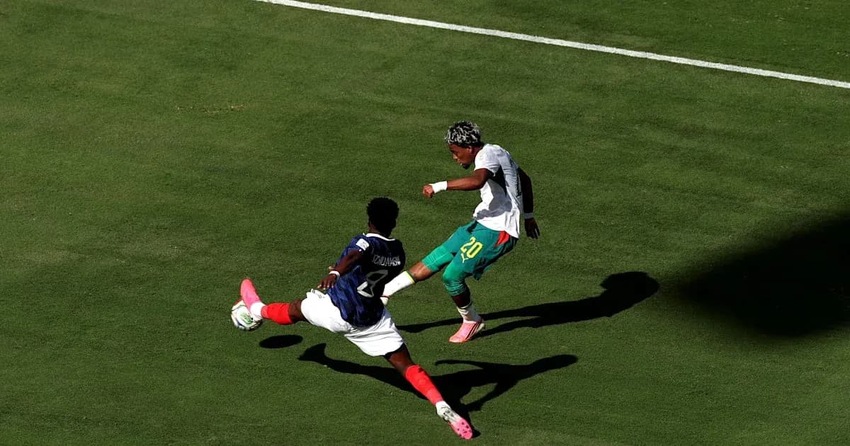 Player tackling opponent during soccer match on field