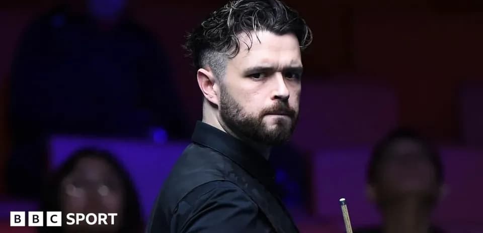 Snooker player posing with cue during match