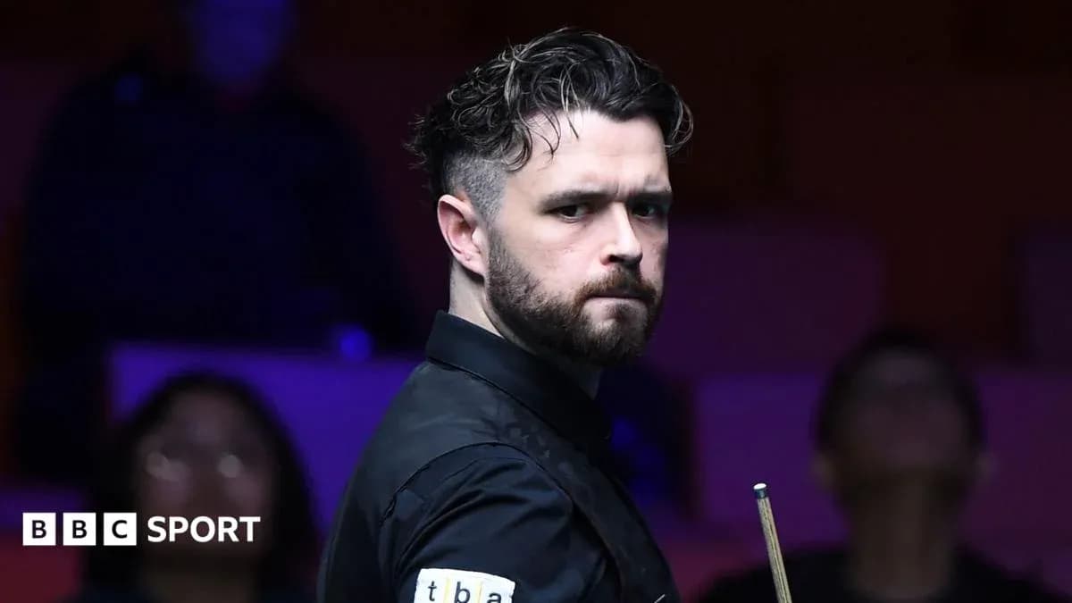 Snooker player posing with cue during match