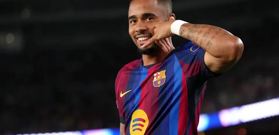 Player celebrating with a phone gesture on pitch