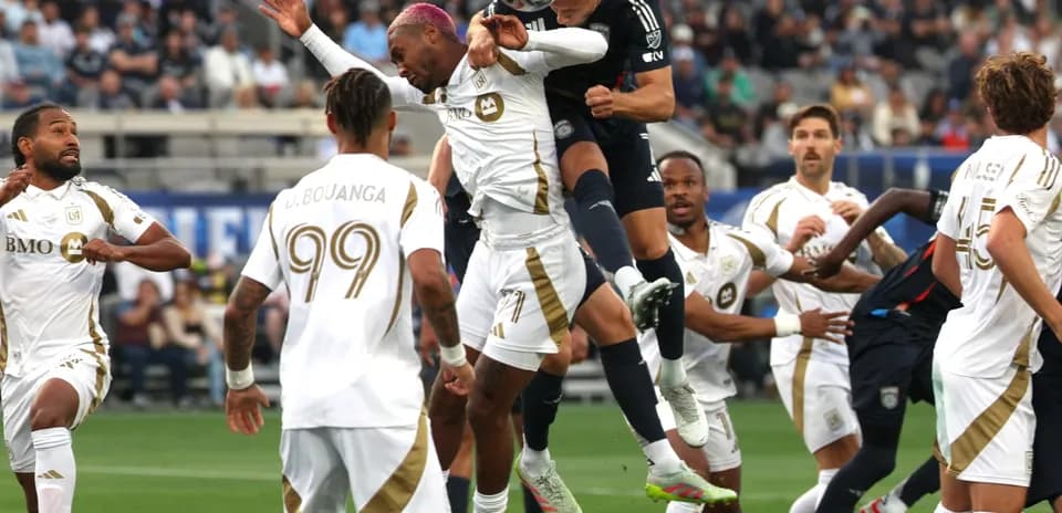 Players competing for the ball in MLS match