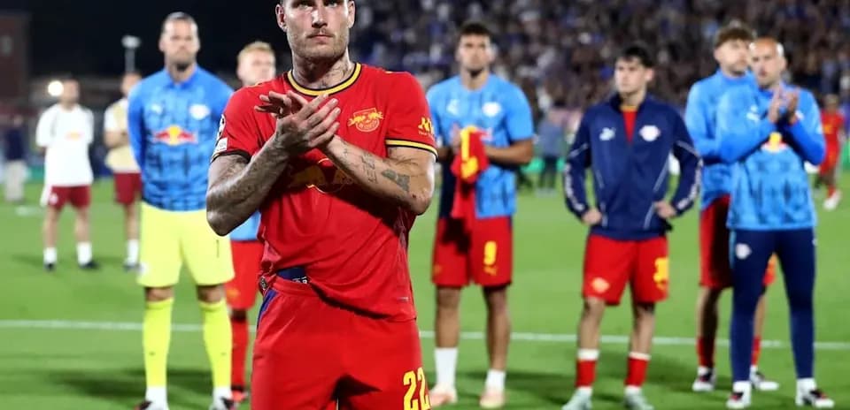 Player applauding with teammates in the background