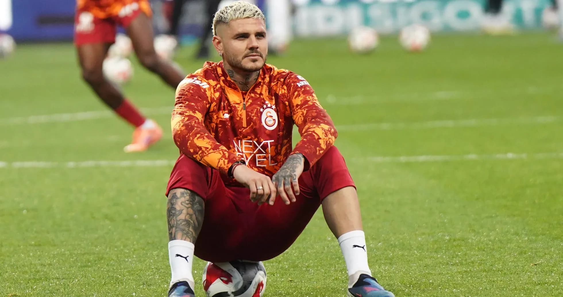 Player sitting on the pitch during warm-up