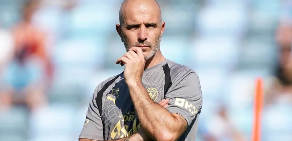 Coach observing training session with arms crossed