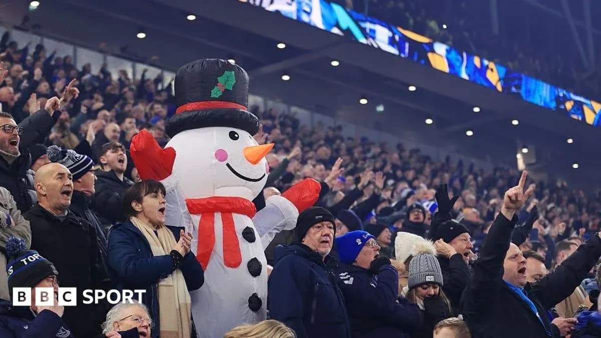 Fans cheering with a large inflatable snowman