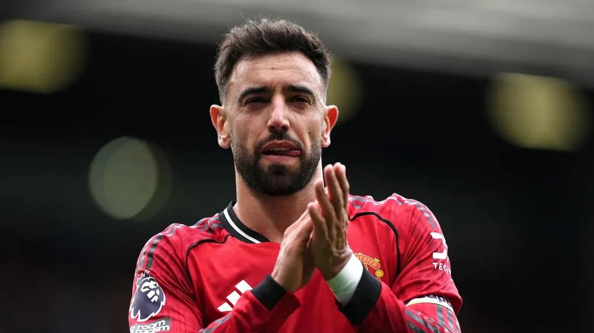 Player applauding fans wearing Manchester United jersey