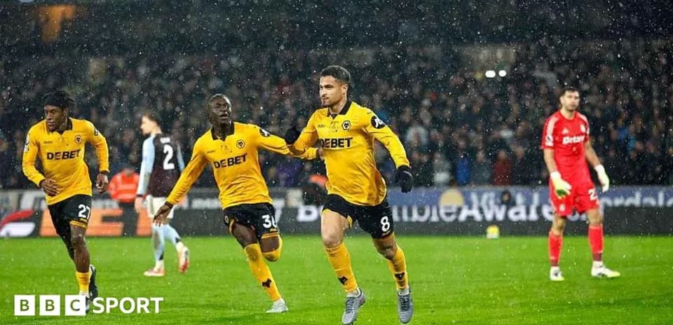Player celebrating a goal during a rainy match