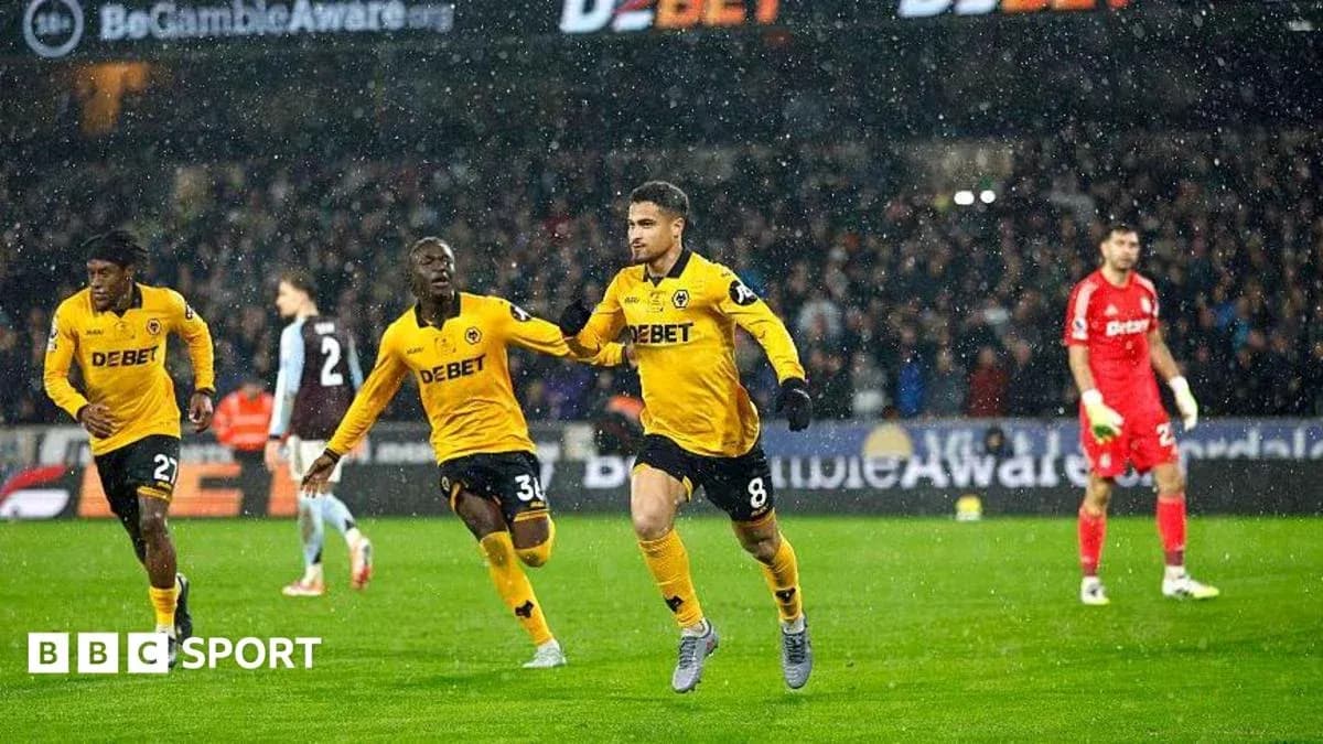 Player celebrating a goal during a rainy match