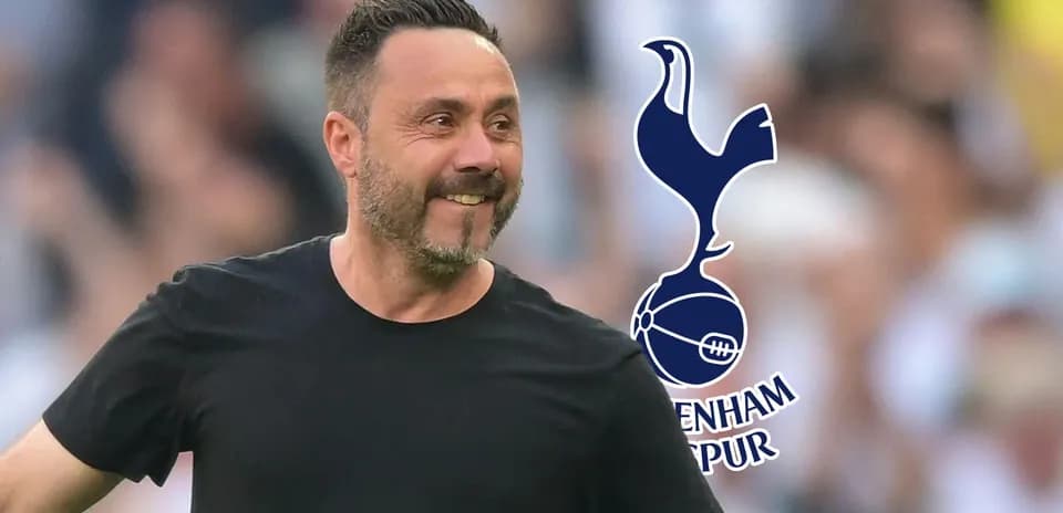 Manager celebrating with Tottenham Hotspur logo behind