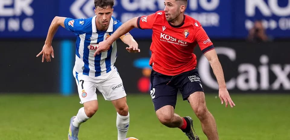Osasuna player chasing Espanyol opponent with ball