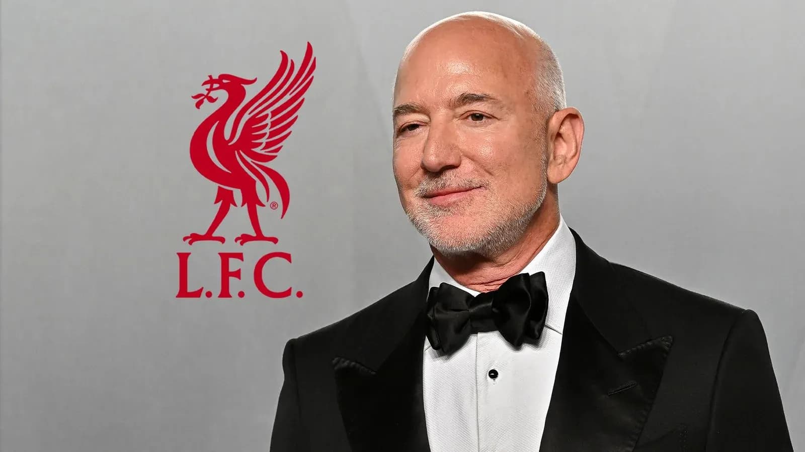 Person in tuxedo with Liverpool FC logo background