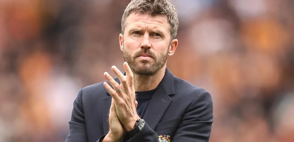 Manager applauding during a match on the sidelines