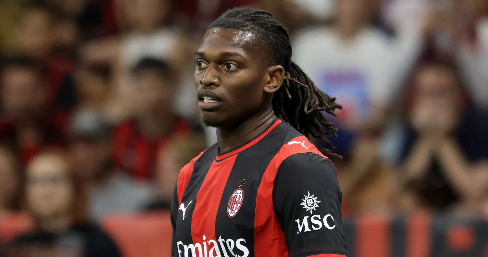 Player in AC Milan jersey during match action