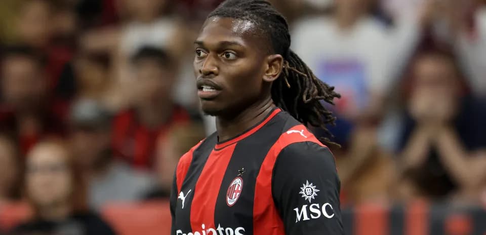 Player in AC Milan jersey during match action