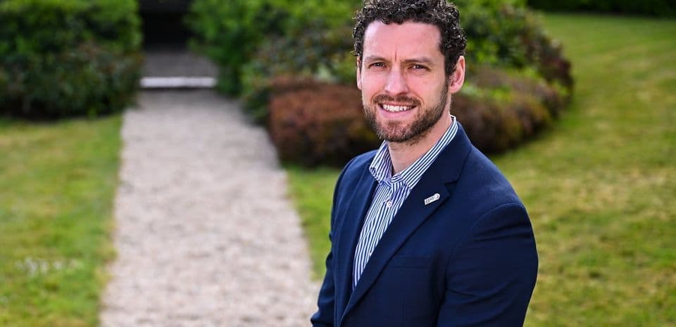 Man in suit standing on garden path