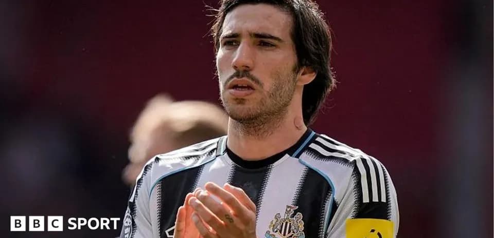Player applauding while wearing Newcastle United jersey