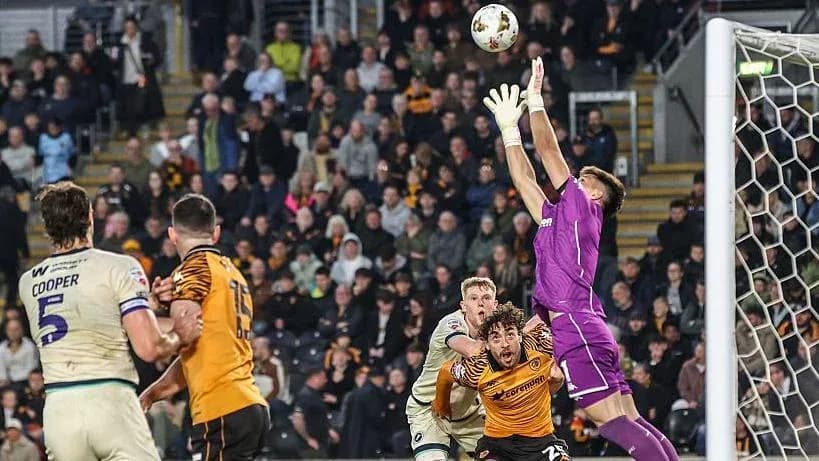 Goalkeeper catching ball during intense match action