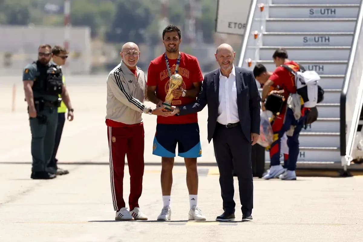 Player receiving trophy at airport arrival ceremony