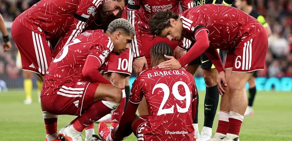 Liverpool players gathered around injured teammate