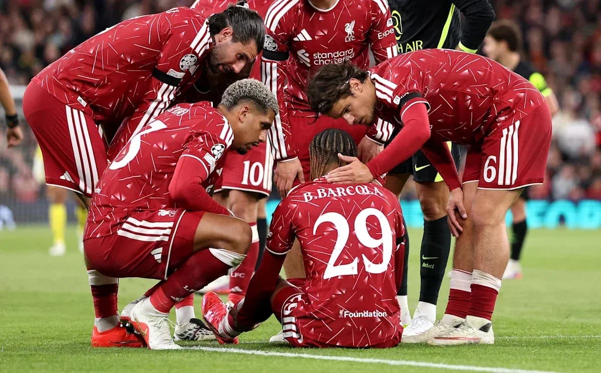 Liverpool players gathered around injured teammate