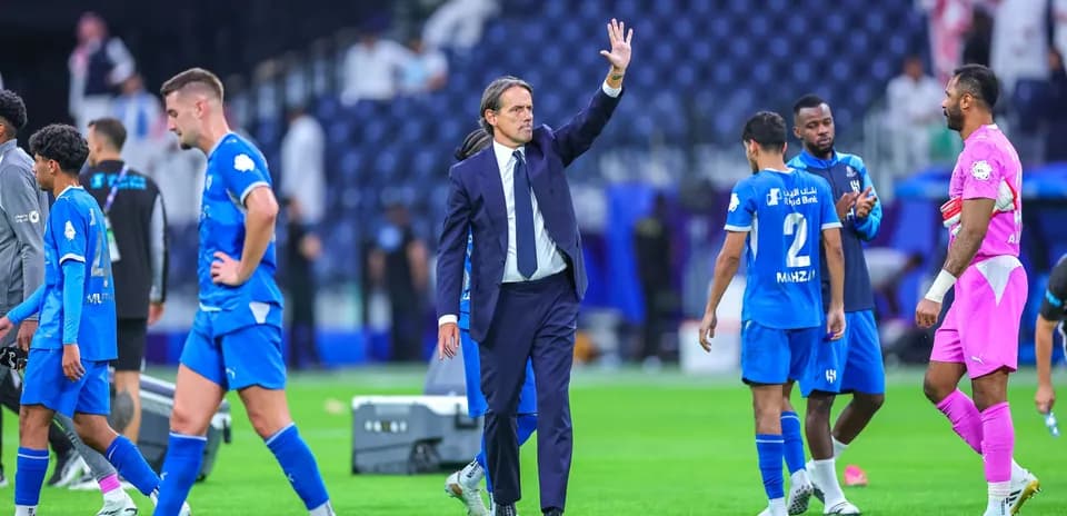 Coach waving to players after match conclusion
