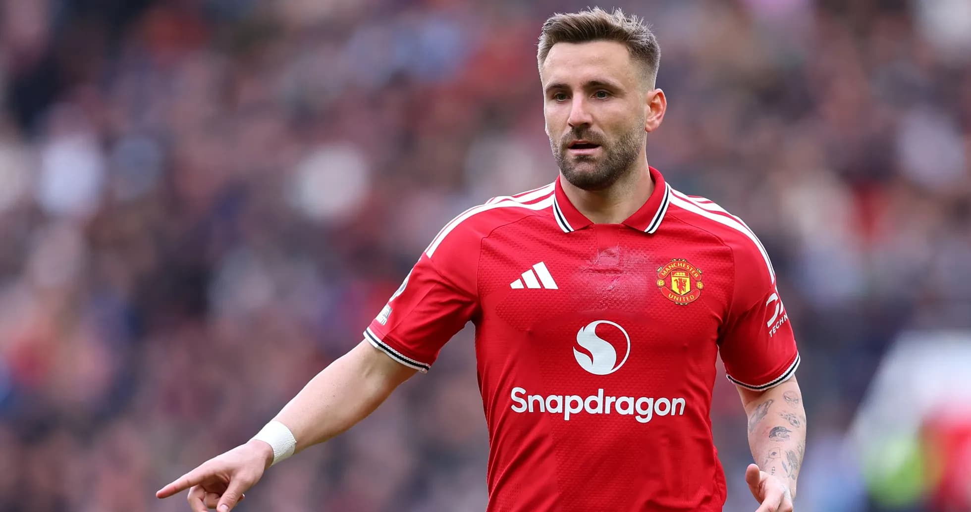 Player in Manchester United jersey gesturing on field