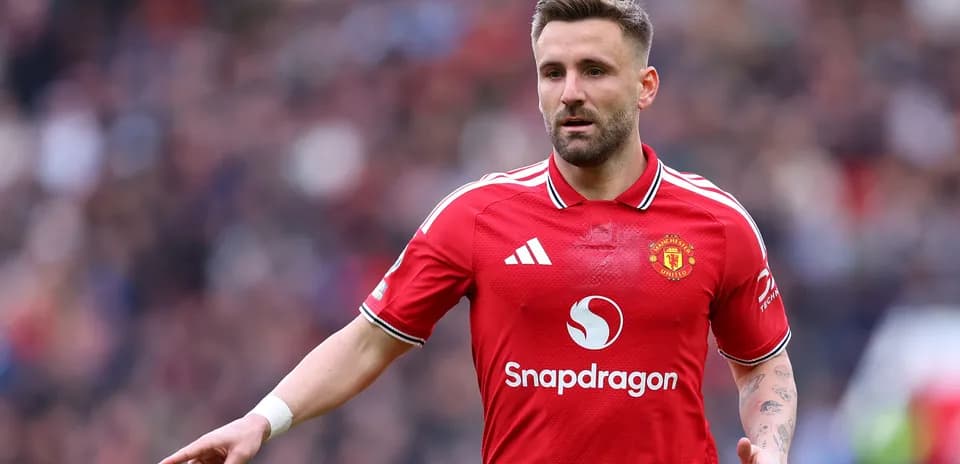 Player in Manchester United jersey gesturing on field