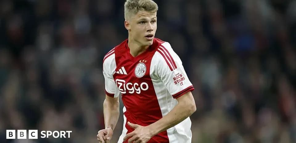 Player in Ajax kit running on the pitch