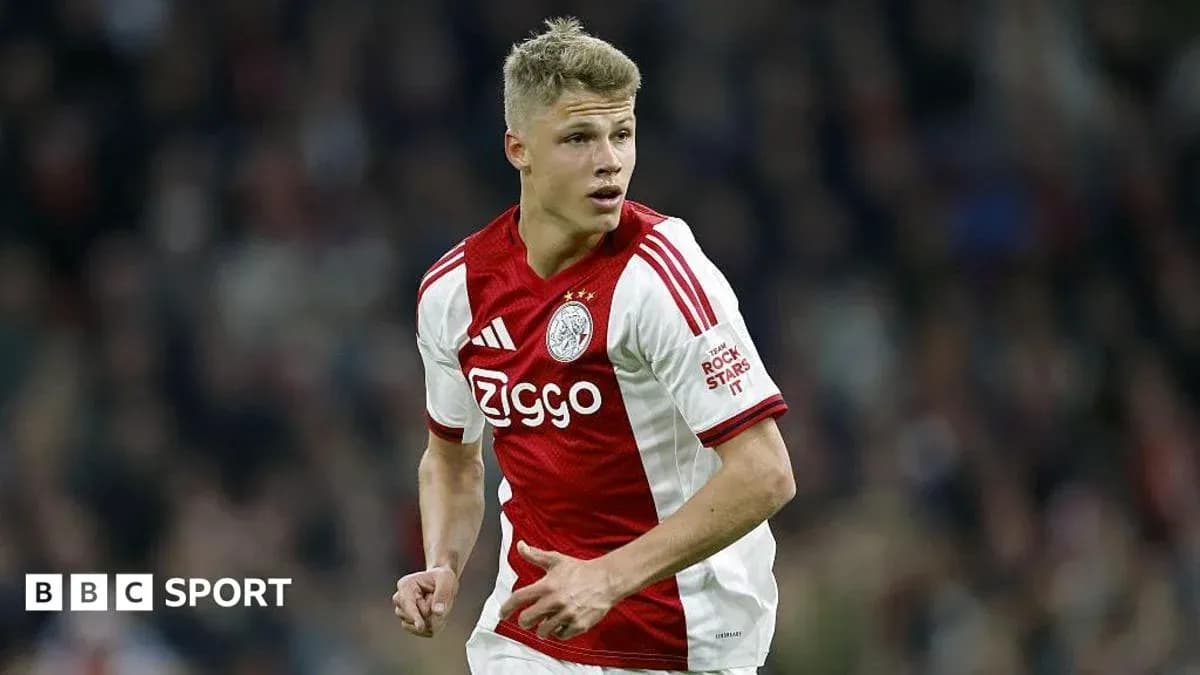 Player in Ajax kit running on the pitch