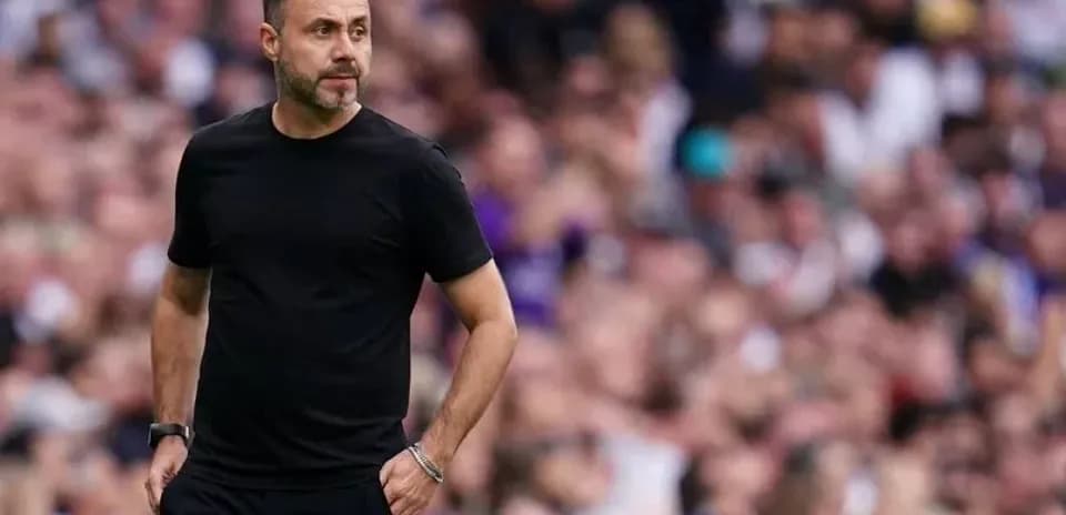 Coach walking along the sidelines during match