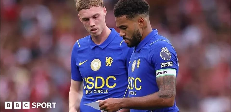 Two Chelsea players discussing strategy on the field