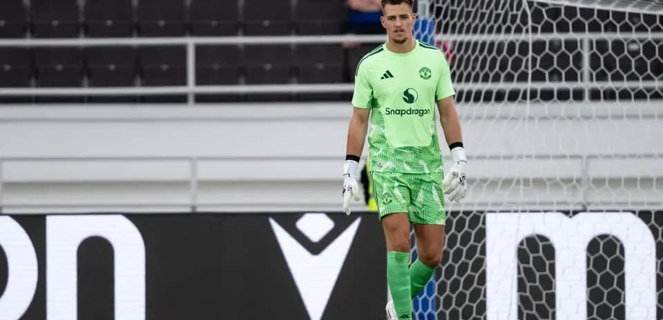 Goalkeeper in green kit standing near goalpost