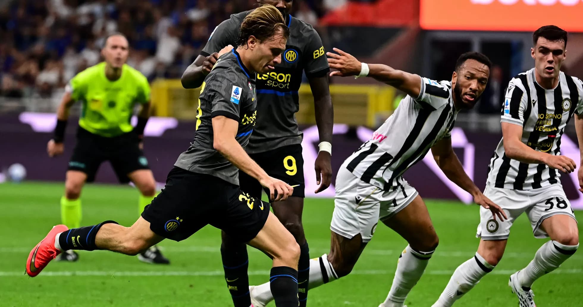 Player dribbling past defenders during a football match