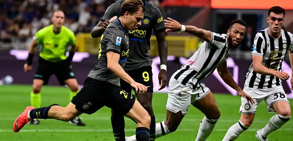 Player dribbling past defenders during a football match