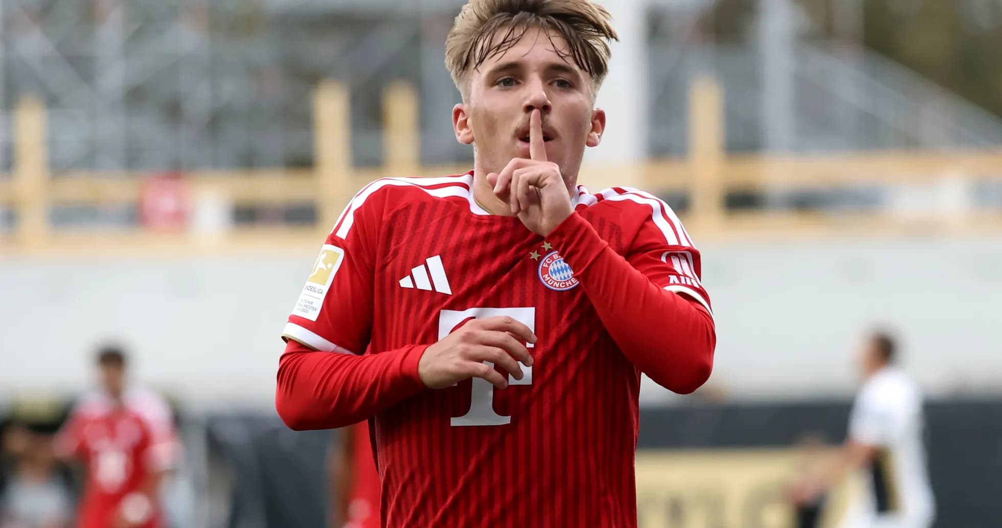 Player celebrating goal with shushing gesture