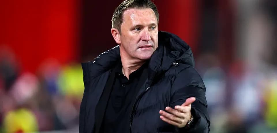 Manager gesturing during a football match on the sideline
