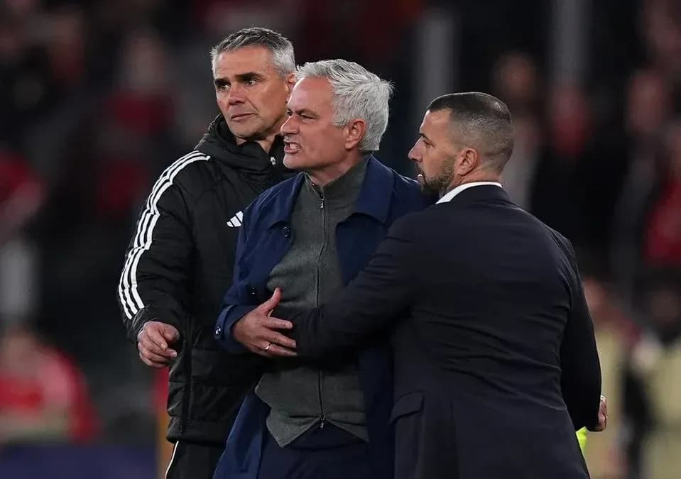 Coach being restrained during heated confrontation