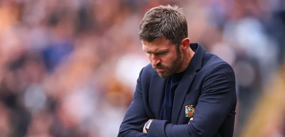 Coach with arms crossed during match contemplation